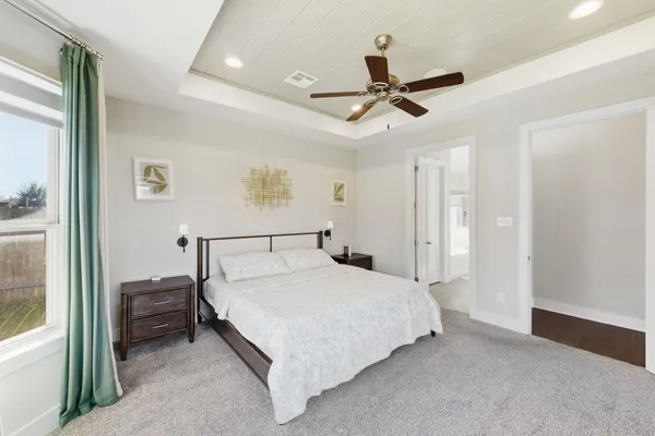 a bedroom with a large bed and a large window