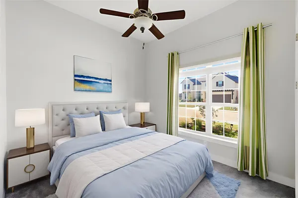 a bedroom with a bed and a ceiling fan