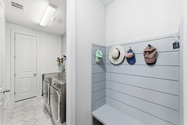 a view of an swimming pool with lawn chairs and plants