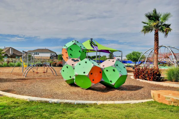 an aerial view of a house with swimming pool garden and glass top table and chairs