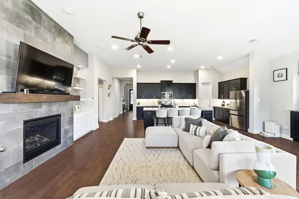 a living room with furniture a fireplace and a flat screen tv