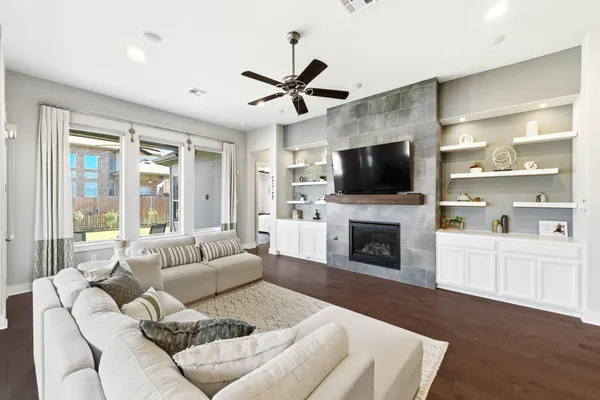 a living room with furniture a fireplace and a flat screen tv
