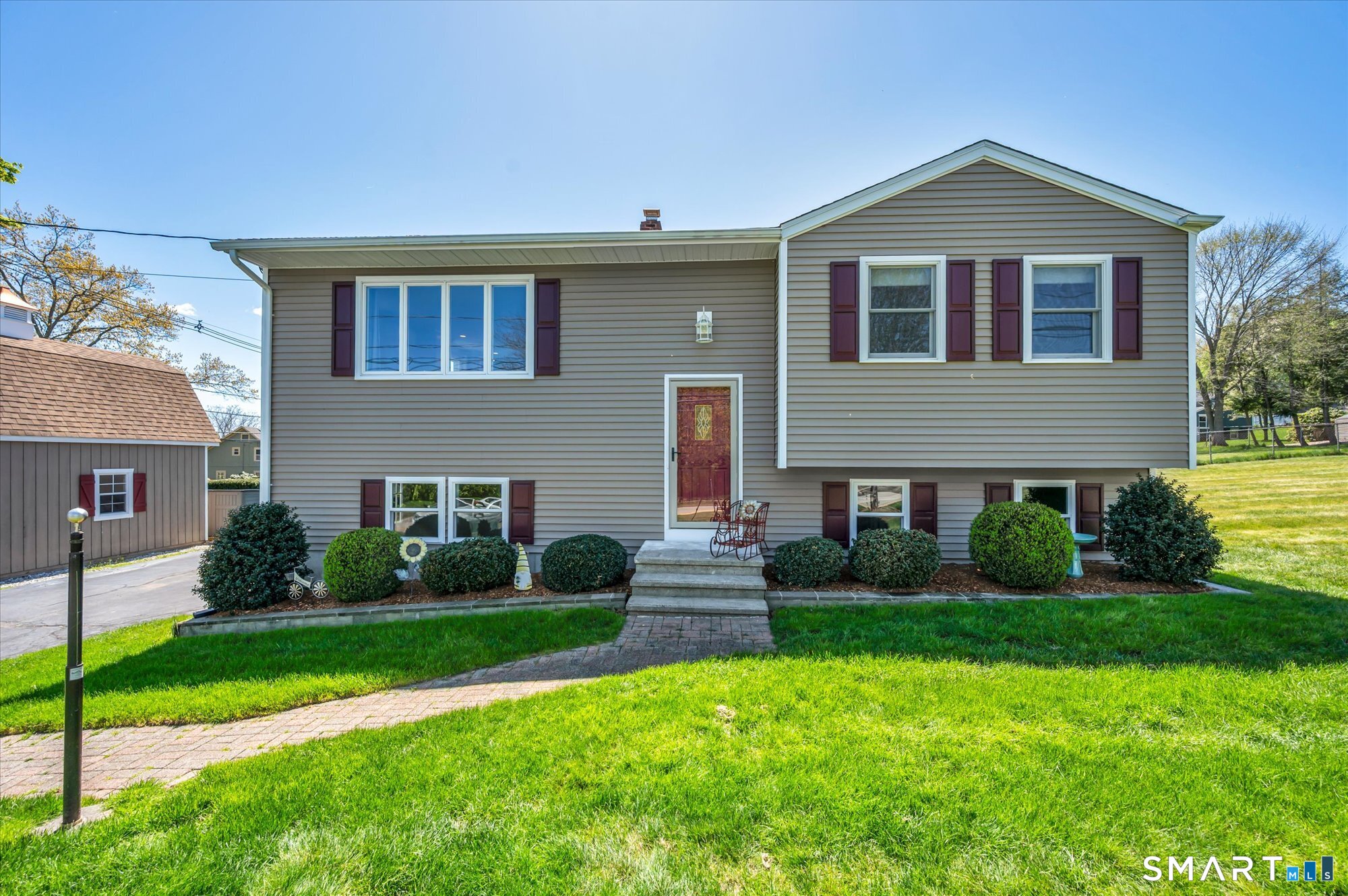 149 Cook Hill Road Wallingford, CT 06492 - Photo 1 of 1 a front view of a house with a yard and garage