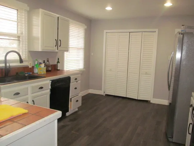 a kitchen with stainless steel appliances a refrigerator sink and cabinets