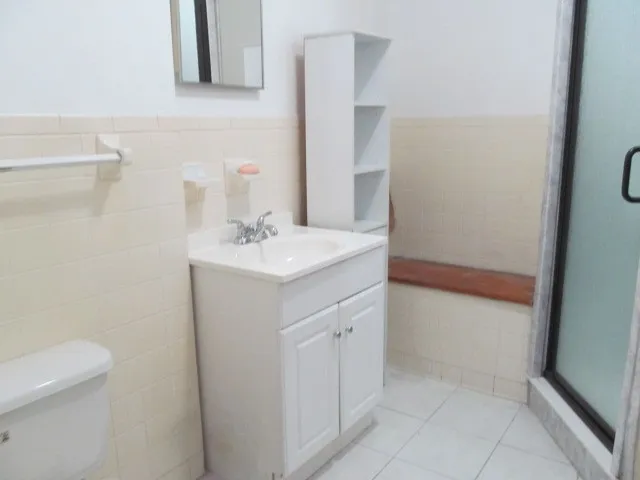 a bathroom with a sink a toilet and a mirror