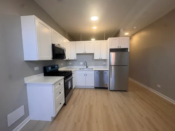 a kitchen with stainless steel appliances a refrigerator stove microwave and sink