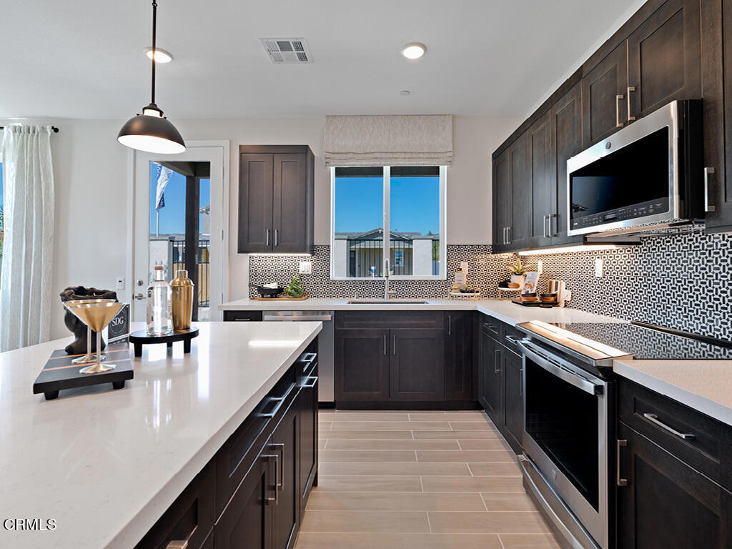 3838 Silvergrass Lane Piru, CA 93040 - Photo 4 of 24 a kitchen with a sink appliances and cabinets