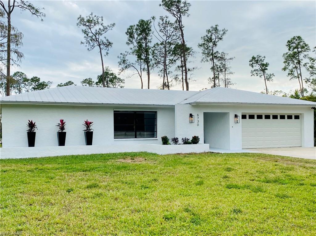 6730 Sable Ridge Lane Naples, FL 34109 - Photo 1 of 27 a view of a house with a yard and potted plants