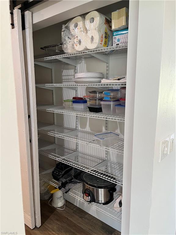 6730 Sable Ridge Lane Naples, FL 34109 - Photo 11 of 27 a kitchen with a wooden floor and cabinets