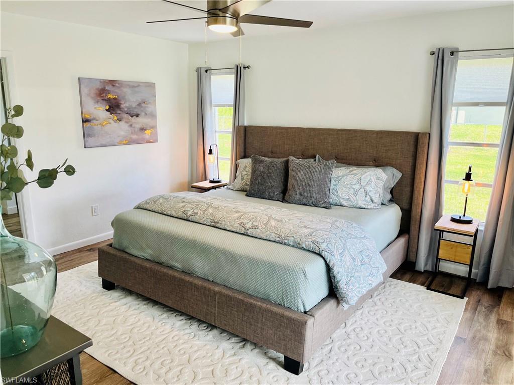 6730 Sable Ridge Lane Naples, FL 34109 - Photo 13 of 27 a bedroom with a bed and a painting on the wall