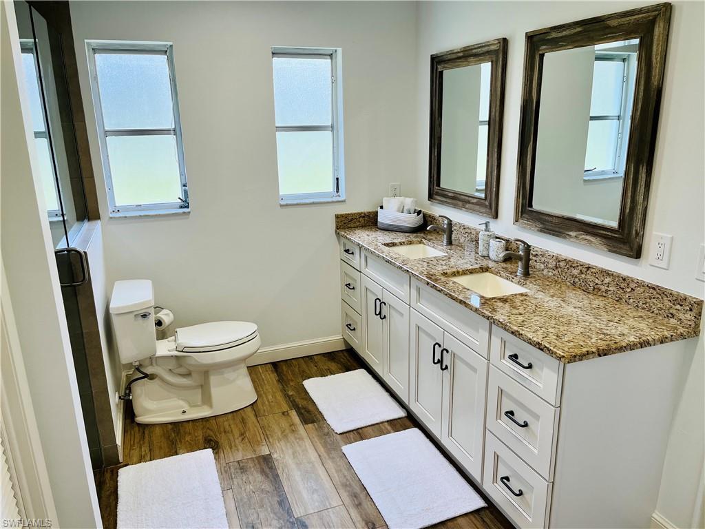 6730 Sable Ridge Lane Naples, FL 34109 - Photo 14 of 27 a bathroom with a granite countertop sink mirror and a toilet