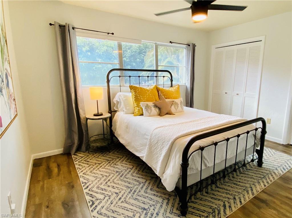 6730 Sable Ridge Lane Naples, FL 34109 - Photo 15 of 27 a bedroom with a bed and wooden floor