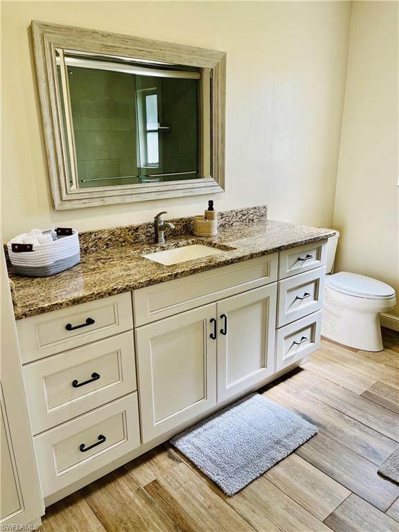 6730 Sable Ridge Lane Naples, FL 34109 - Photo 17 of 27 a bathroom with a granite countertop sink and a mirror