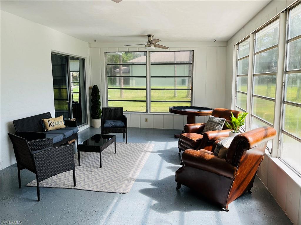 6730 Sable Ridge Lane Naples, FL 34109 - Photo 19 of 27 a living room with furniture and a window