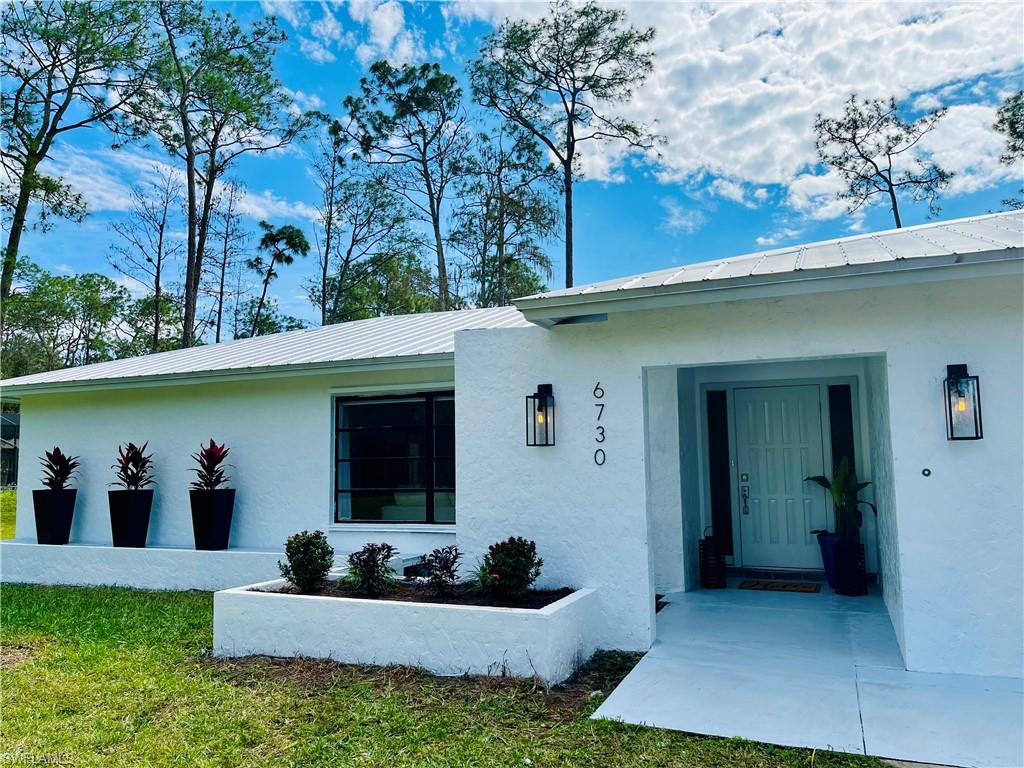 6730 Sable Ridge Lane Naples, FL 34109 - Photo 2 of 27 a house view with a outdoor space
