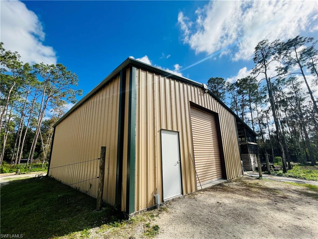 6730 Sable Ridge Lane Naples, FL 34109 - Photo 23 of 27 a view of a house with backyard and trees