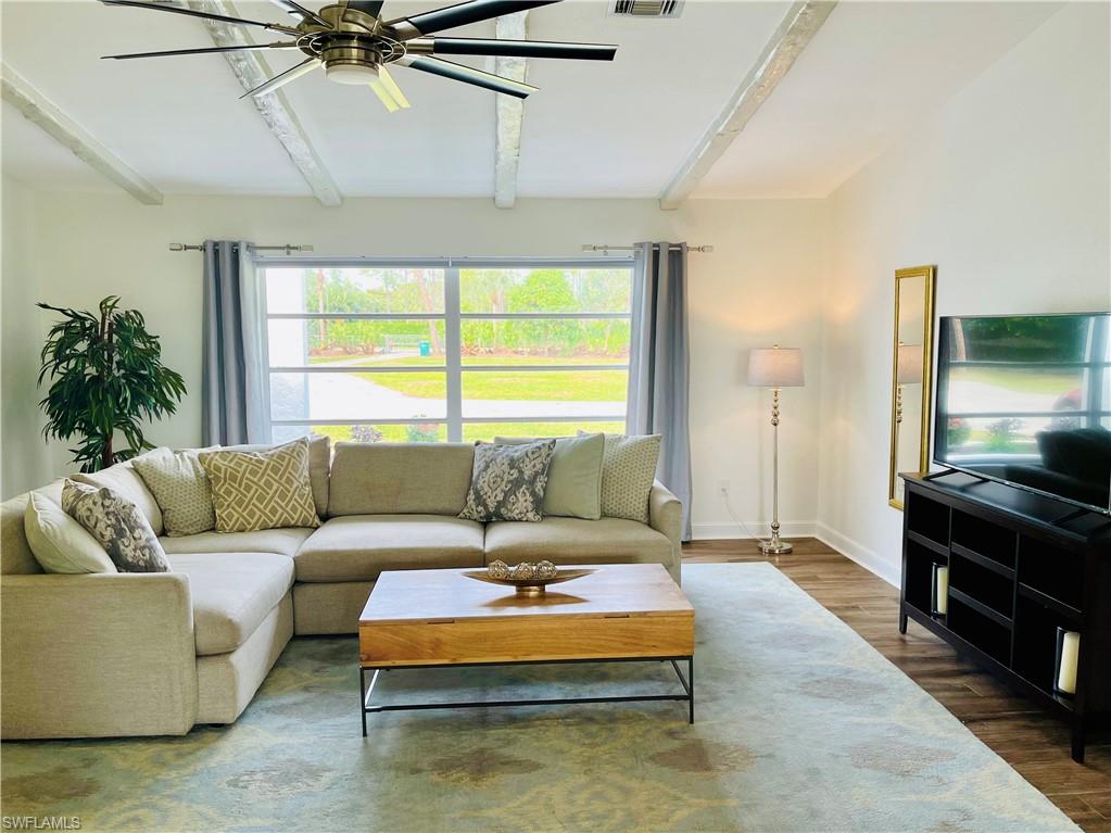 6730 Sable Ridge Lane Naples, FL 34109 - Photo 7 of 27 a living room with furniture and a large window