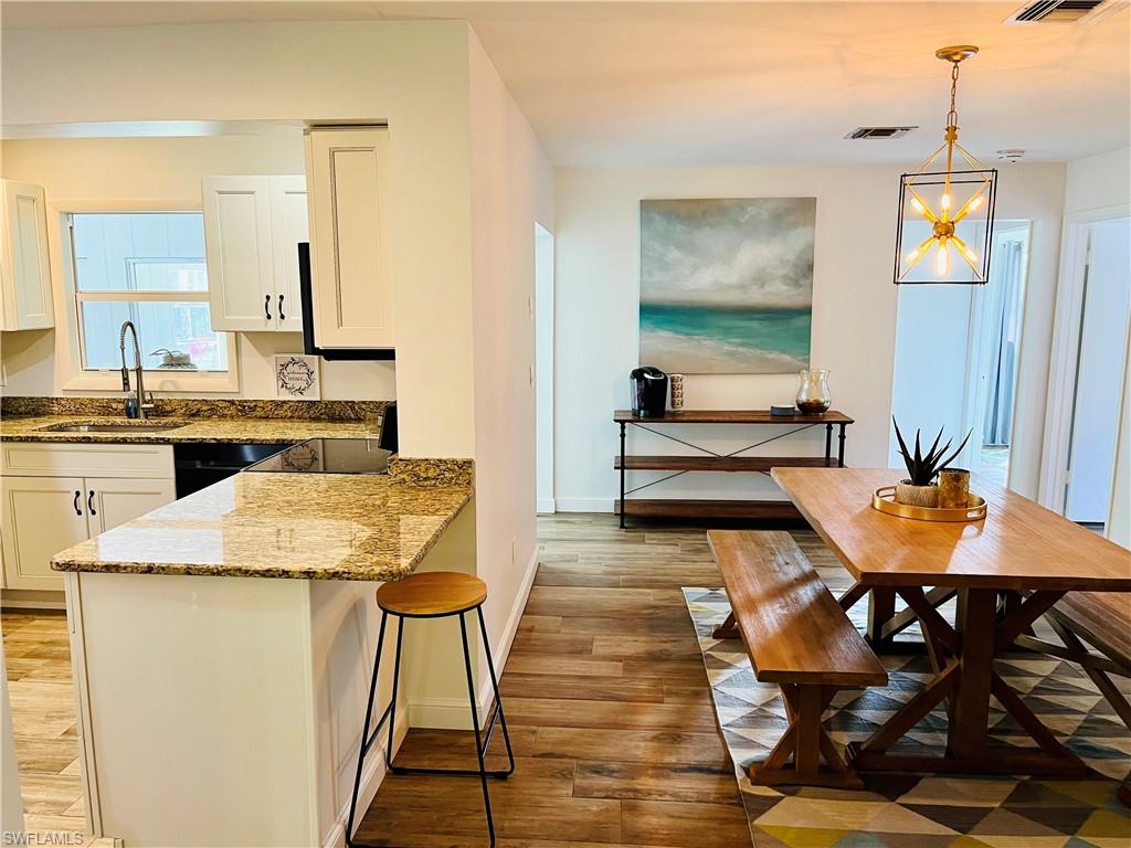 6730 Sable Ridge Lane Naples, FL 34109 - Photo 10 of 27 a view of a dining room with furniture and wooden floor