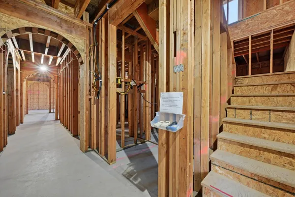 a view of a hallway with wooden floor and entryway