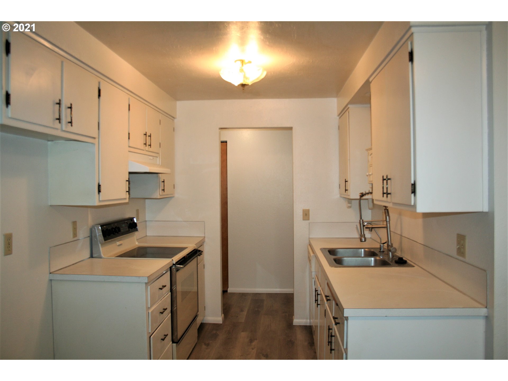 1167 T Street Springfield, OR 97477 - Photo 8 of 16 a kitchen with stainless steel appliances a sink stove and cabinets