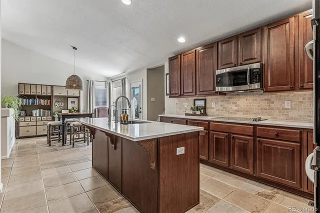a kitchen with stainless steel appliances granite countertop a stove top oven a sink dishwasher and cabinets