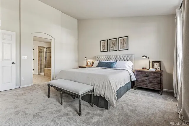 a bedroom with a bed and a table