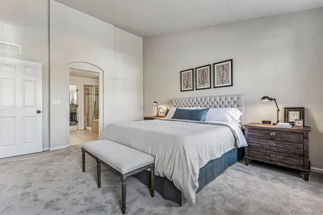 a bedroom with a bed and a table