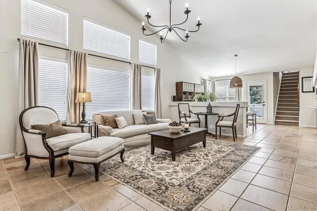 a living room with patio furniture and a table