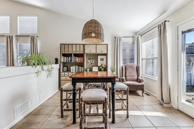a view of a dining room with furniture and window