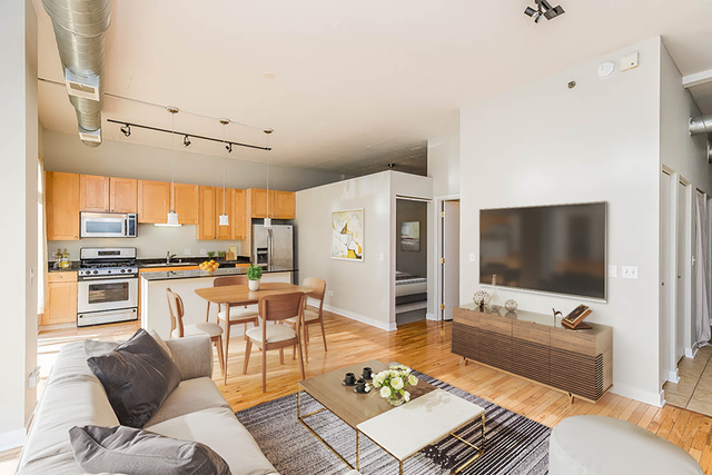 910 West Madison Street, Unit 703 Chicago, IL 60607 - Photo 2 of 23 a living room with furniture and a flat screen tv