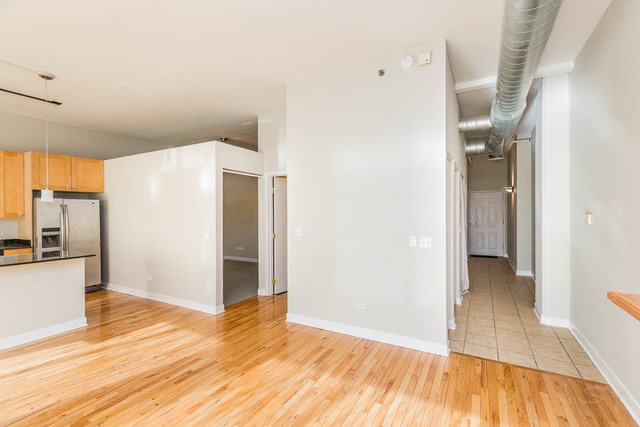 910 West Madison Street, Unit 703 Chicago, IL 60607 - Photo 20 of 23 a view of a big room with wooden floor and furniture