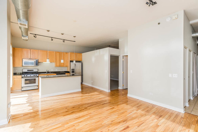 910 West Madison Street, Unit 703 Chicago, IL 60607 - Photo 3 of 23 a view of a kitchen with wooden floor