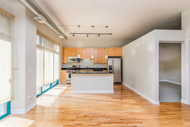 910 West Madison Street, Unit 703 Chicago, IL 60607 - Photo 21 of 23 a large white kitchen with white cabinets