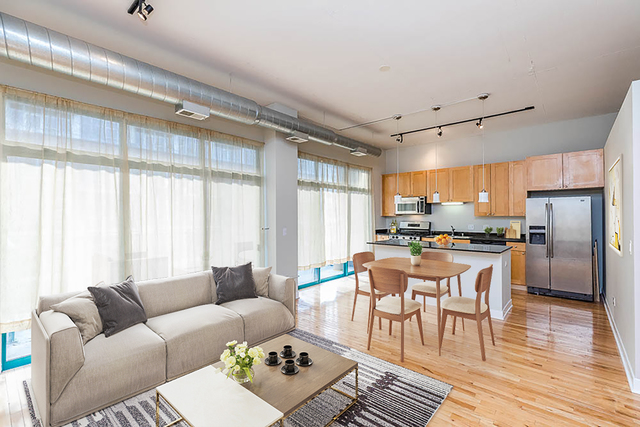 910 West Madison Street, Unit 703 Chicago, IL 60607 - Photo 4 of 23 a living room with furniture and a large window