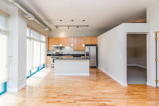 910 West Madison Street, Unit 703 Chicago, IL 60607 - Photo 7 of 23 a kitchen with stainless steel appliances a refrigerator and a stove top oven
