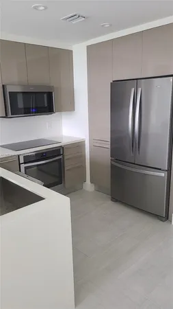 a kitchen with stainless steel appliances a refrigerator and a stove top oven