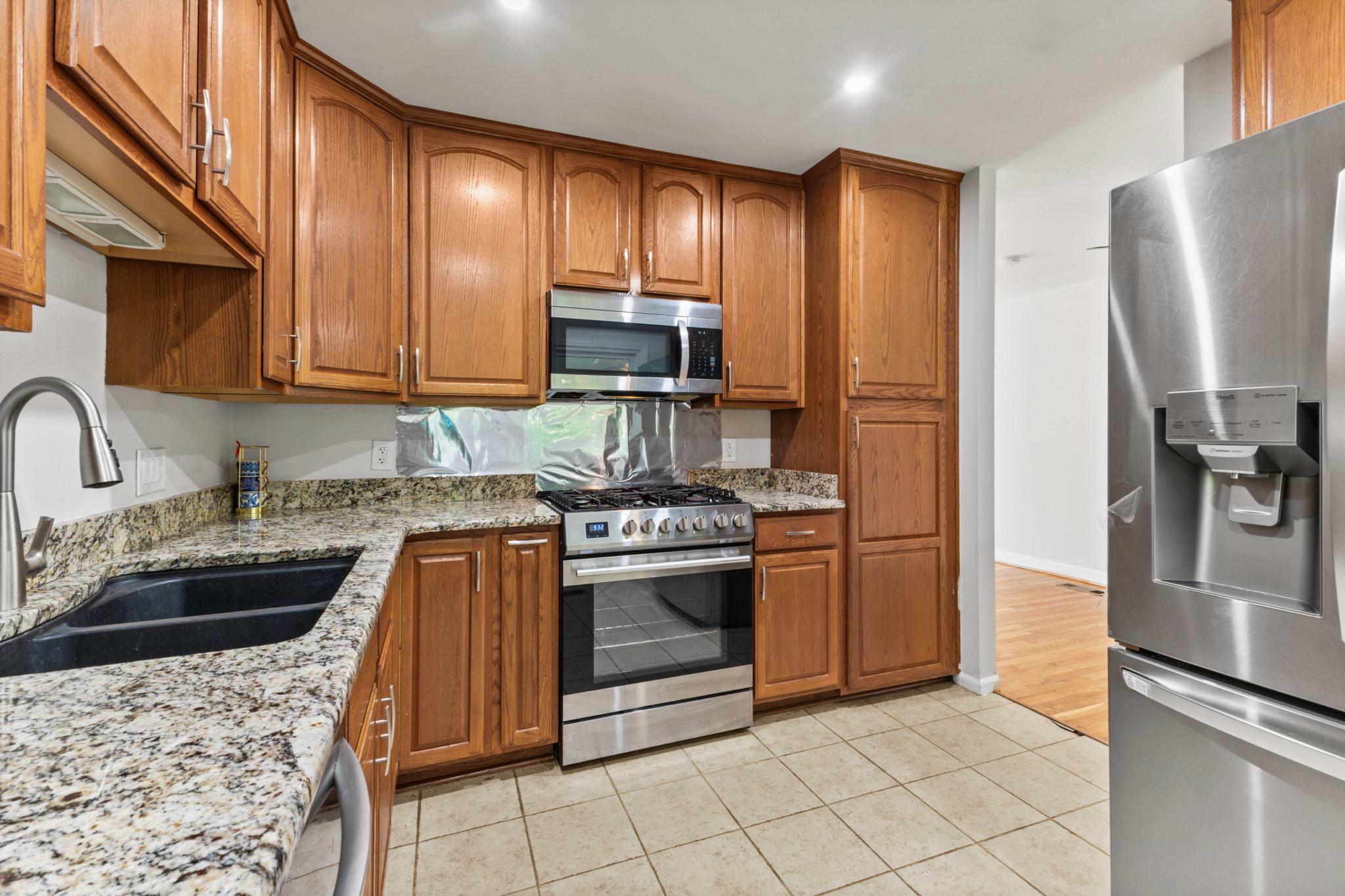 403 West Poplar Road Sterling, VA 20164 - Photo 6 of 25 Modern kitchen with warm finishes.