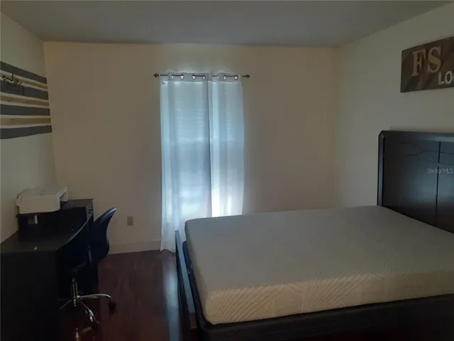 a view of a room with furniture and wooden floor