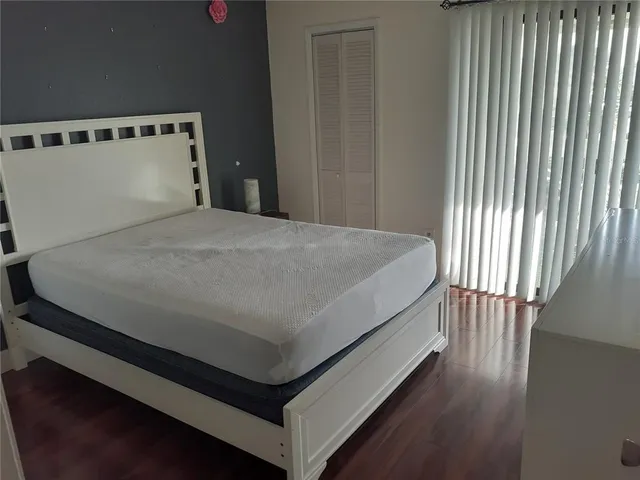 a bed sitting in a bedroom next to a window