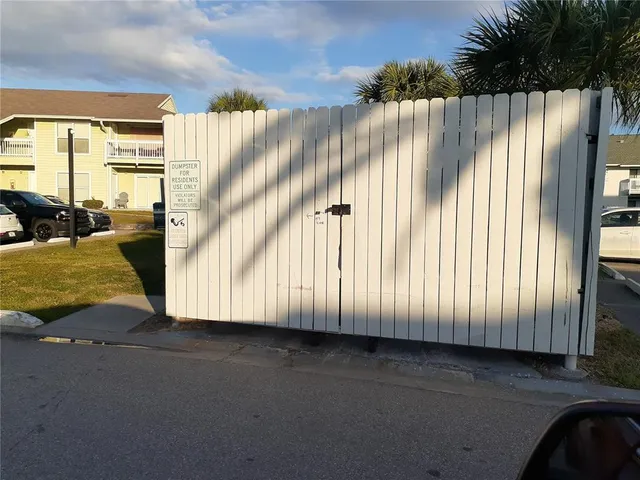 a view of a kitchen with a sink a microwave and cabinets
