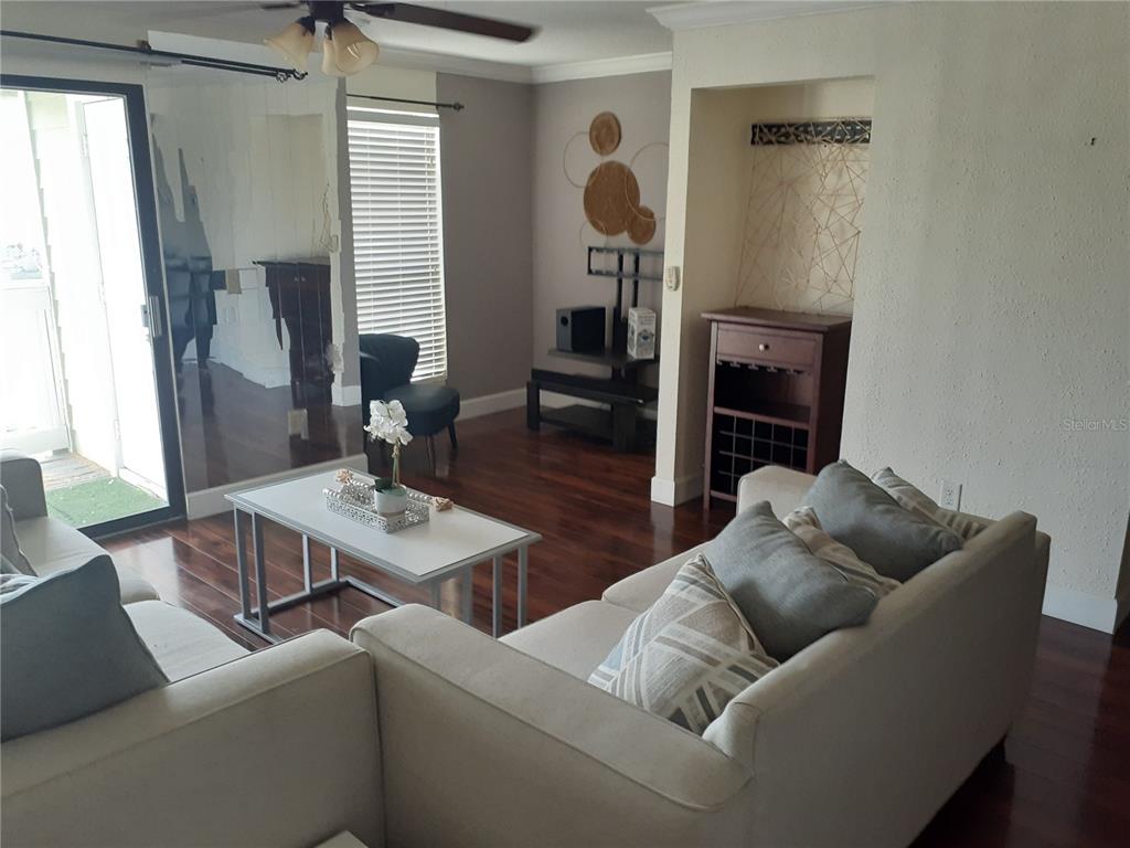 455 Alt 19, Unit 16 Palm Harbor, FL 34683 - Photo 3 of 25 a living room with furniture and a fireplace