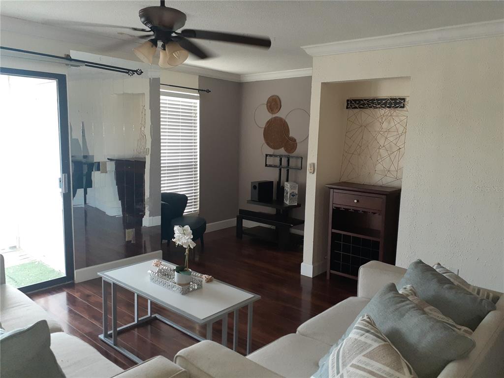 455 Alt 19, Unit 16 Palm Harbor, FL 34683 - Photo 4 of 25 a living room with furniture and a window