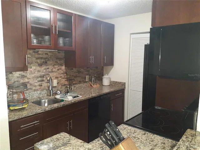 a kitchen with a sink and a refrigerator