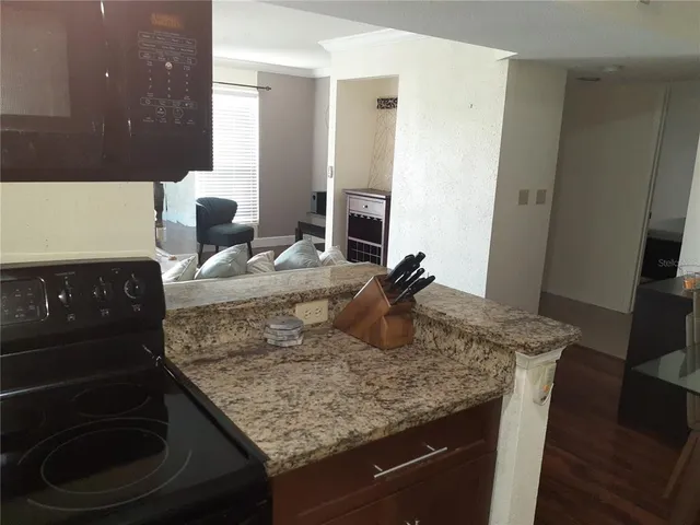 a kitchen with a granite countertop sink and stove