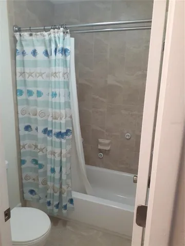 a bathroom with a shower curtain and a bath tub
