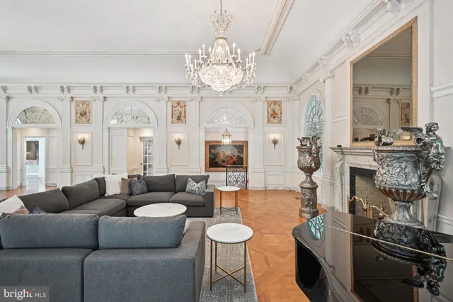 a living room with furniture and a chandelier