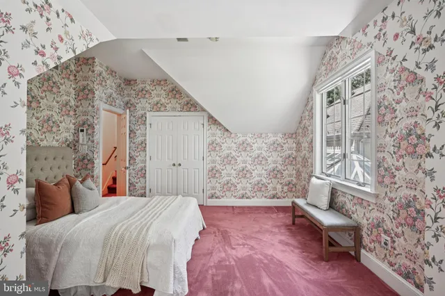 a kitchen with a sink white cabinets and glass table chairs