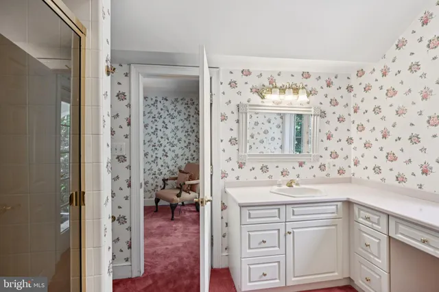 a large white kitchen with a sink and cabinets