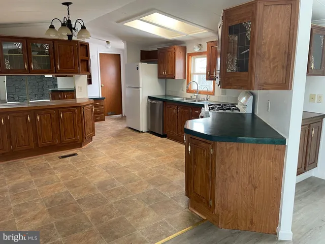 a kitchen with granite countertop a sink and a stove