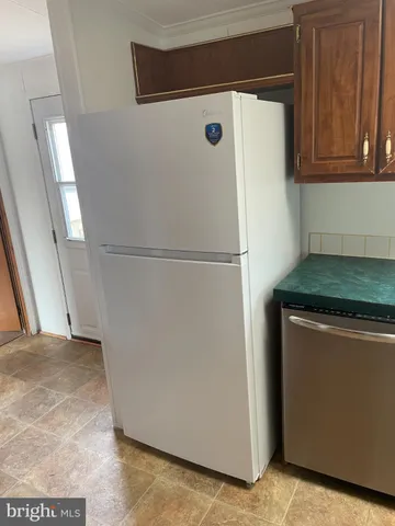 a white refrigerator freezer sitting in a kitchen
